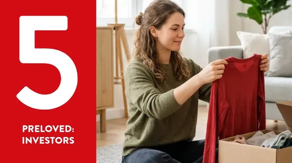 A woman in a green sweater holds up a red long-sleeved shirt. Next to her is a cardboard box filled with clothes. A large white number 5 is on a red background, with "PRELOVED: INVESTORS" below it.