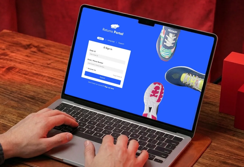 Person using a laptop showing a returns portal login page with images of sneakers on a blue background.