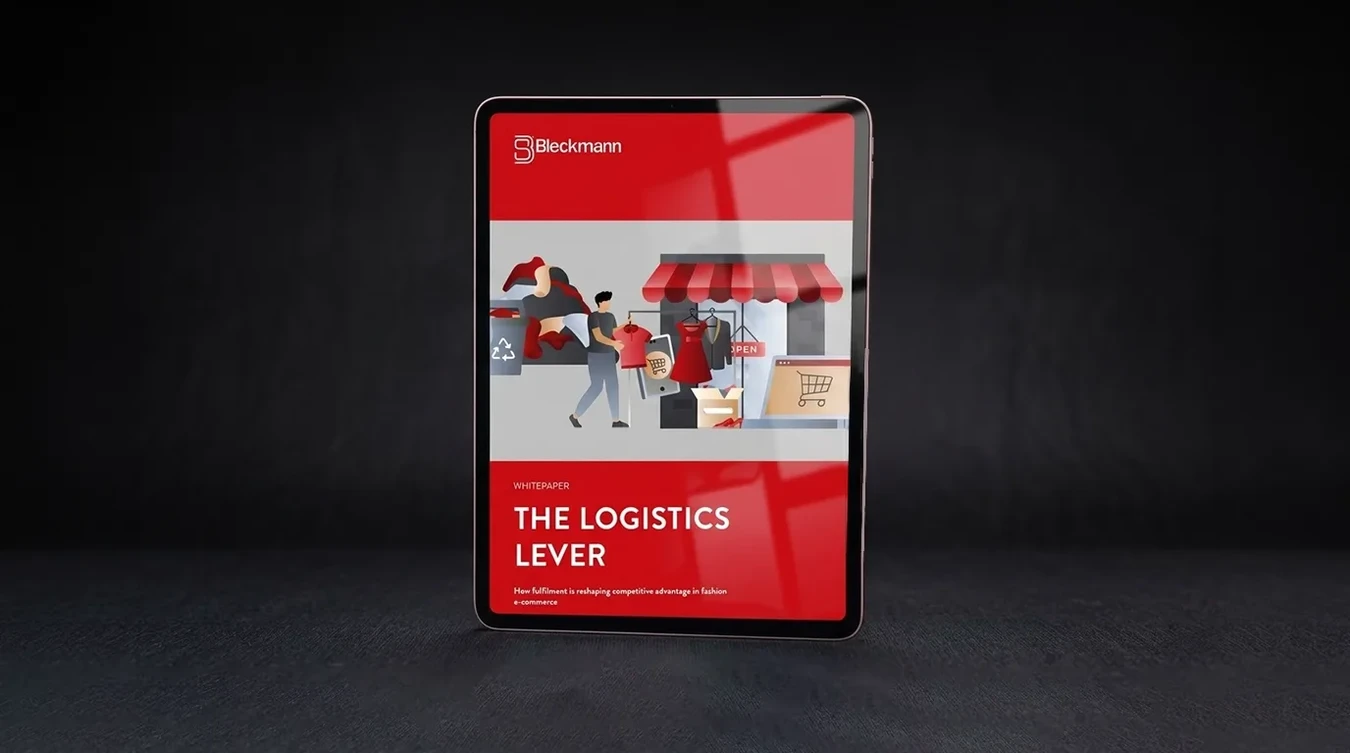 A tablet displays a red and white digital document titled “The Logistics Lever” by Beckmann, featuring illustrated people handling packages at a storefront.