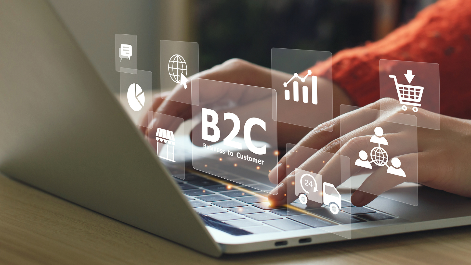 Hands typing on a laptop keyboard with floating digital icons related to B2C (Business to Customer), including shopping cart, graphs, and communication symbols.