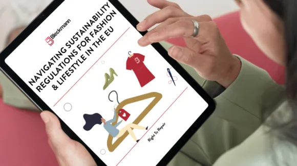 A person holds a tablet displaying a document titled "Navigating Sustainability Regulations for Fashion & Lifestyle in the EU," with clothing and shopping graphics on the screen.