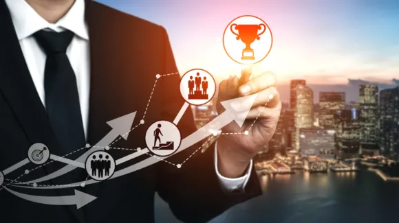 A person in a business suit draws arrows and icons symbolizing progress and achievement, with a city skyline in the background.