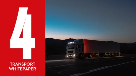 A large truck travels on a highway at dusk with a red panel on the left displaying the number 4 and the words "Transport Whitepaper.
