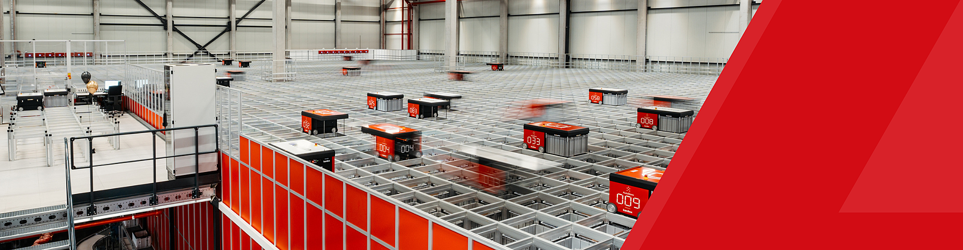 Automated robots move along a grid system in a modern warehouse facility, handling storage and retrieval tasks efficiently.