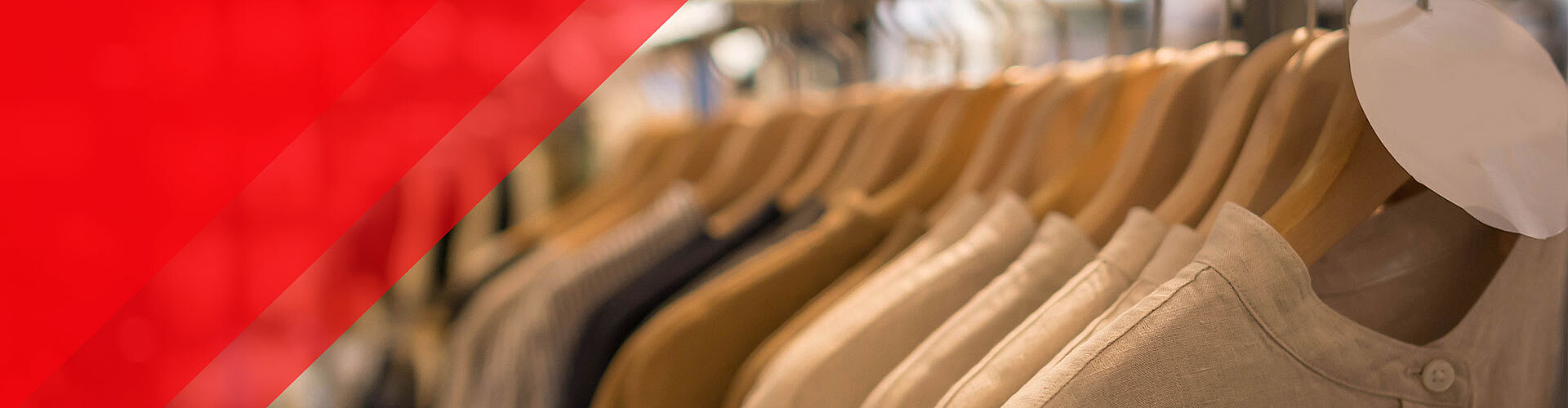 A clothing rack displays several neutral-toned shirts on wooden hangers; a red transparent geometric overlay appears on the left side of the image.