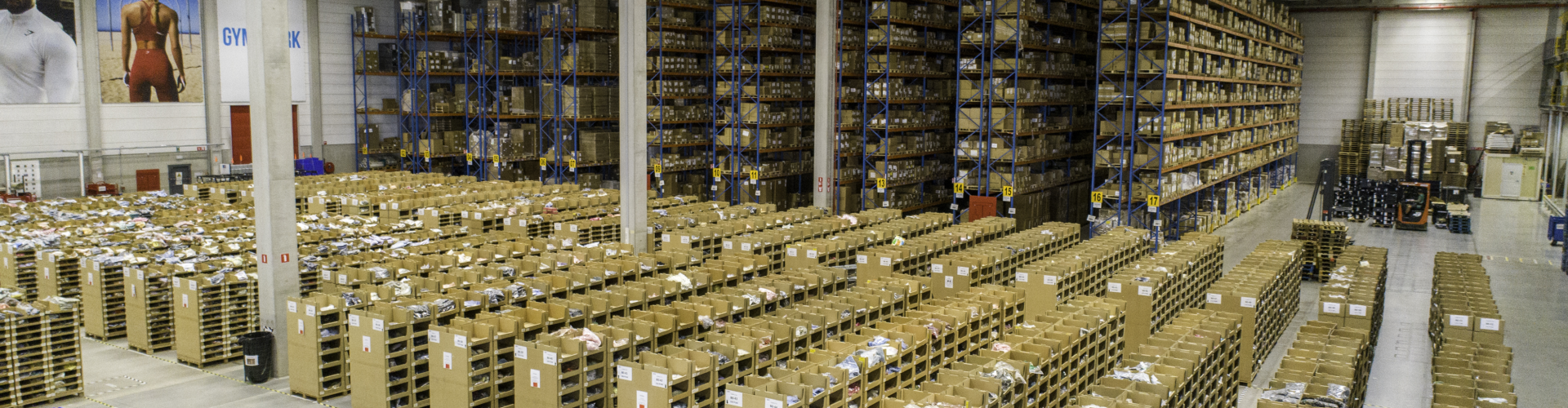 Warehouse with gymshark banners in the background