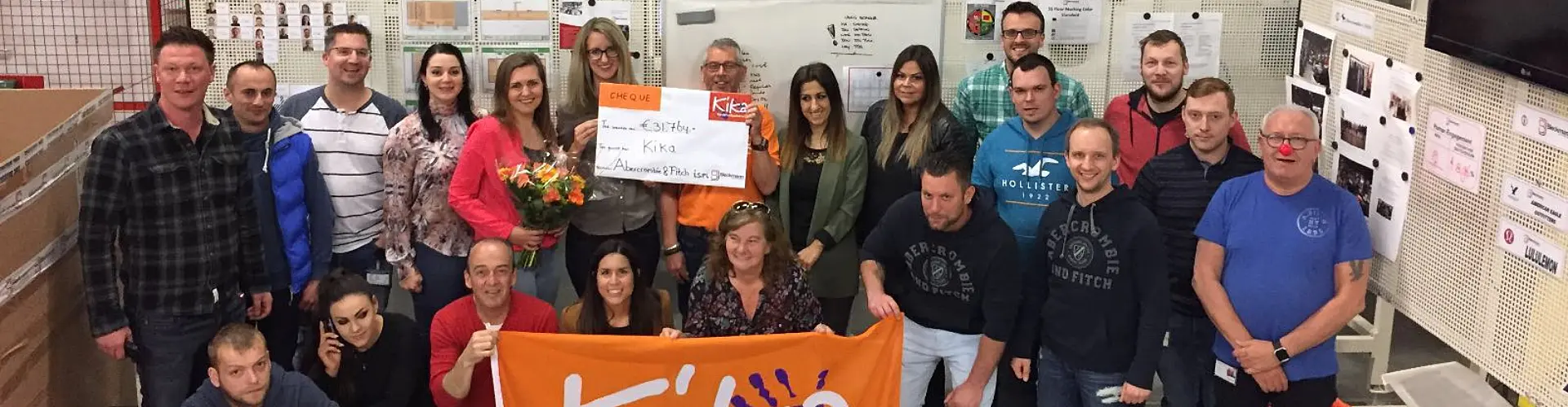 Group of people posing with Kika donation cheque