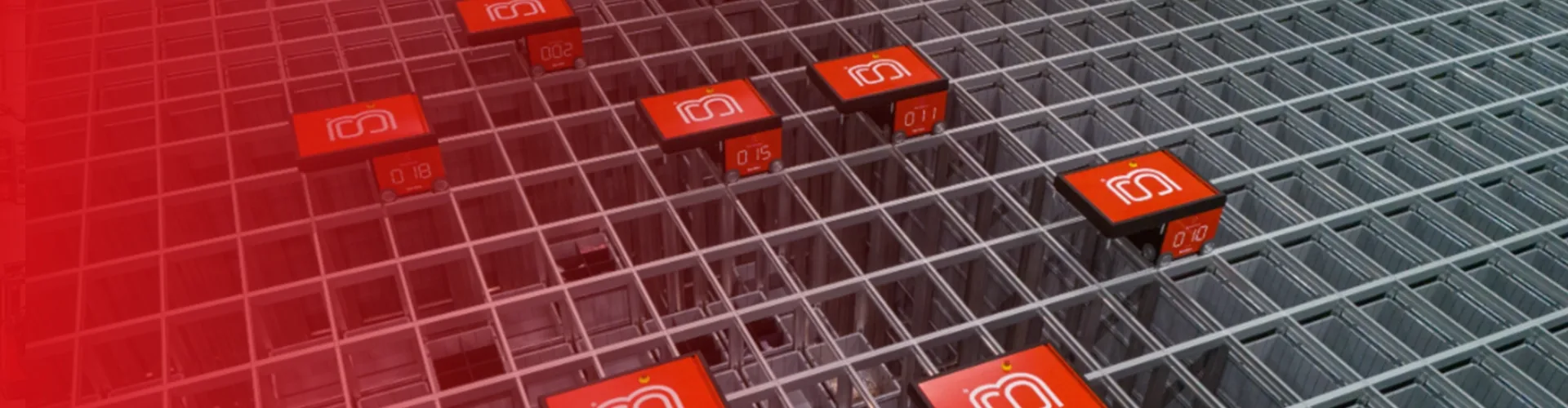 Several red autonomous robots move along a grid of metal tracks in a warehouse automation system.