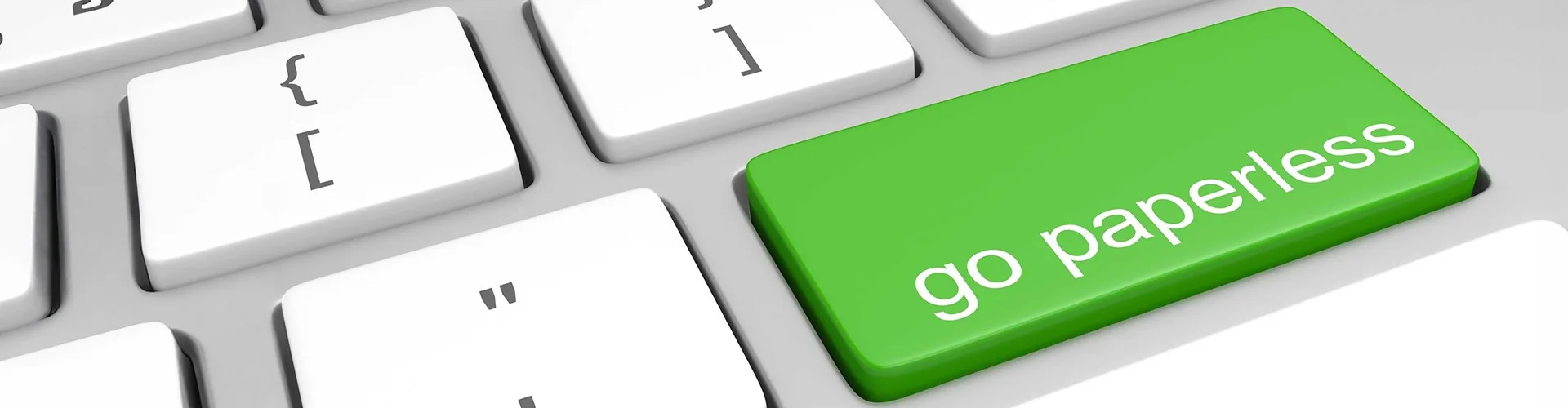 A computer keyboard with a green key labeled “go paperless” in place of the Enter key.
