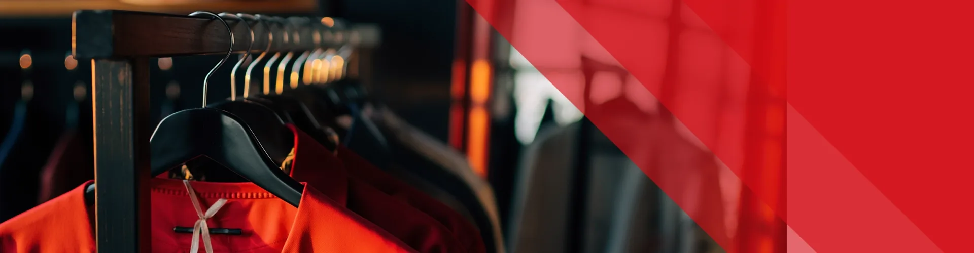 Clothes hanging on black hangers on a rack, with a focus on a red shirt in the foreground and a red transparent overlay on the right side of the image.