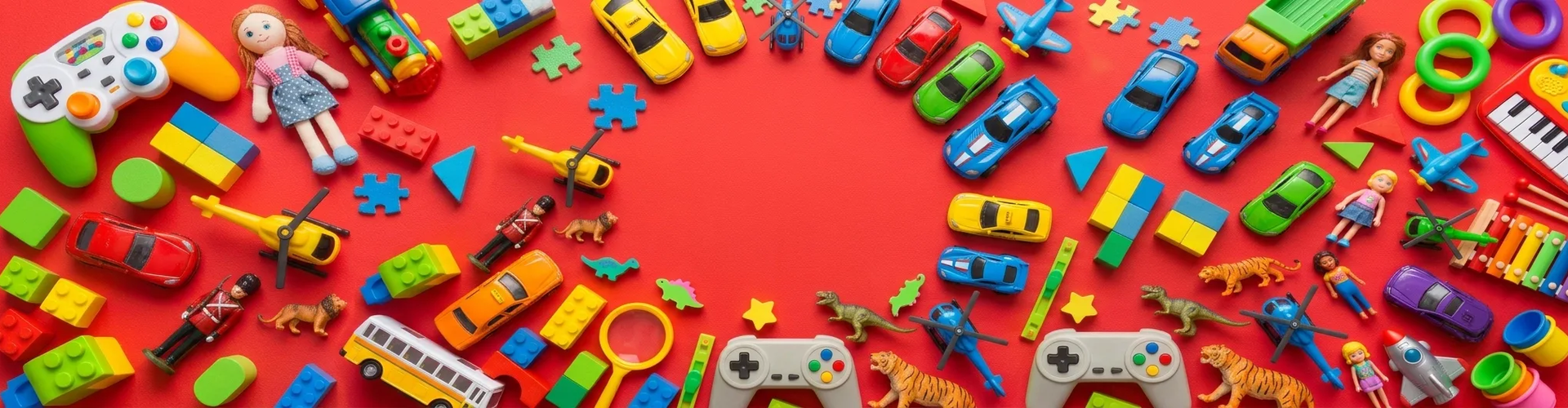 Various colorful toys, including cars, dolls, dinosaurs, building blocks, puzzles, and game controllers, arranged in a semi-circle on a red background.